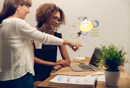 Two young entrepreneur women, and fashion designer working on her atelierの写真素材