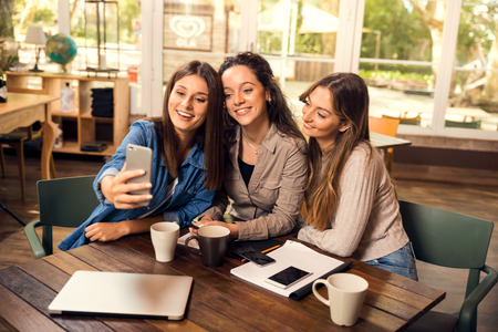 Groups of female firends making a selfie during a pause on the studies