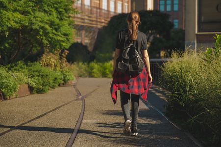 Beautiful woman walking on the HighLine Park, NYCの写真素材