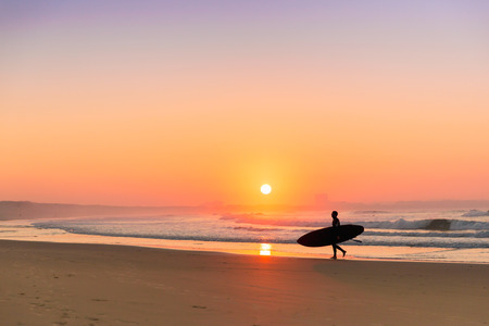 Surfer leaving the ocean after a long day of surf(