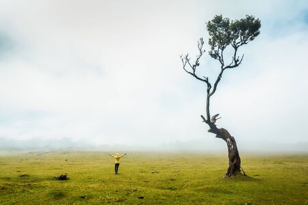 Traveller woman feeling the power of the nature at an ancient forest