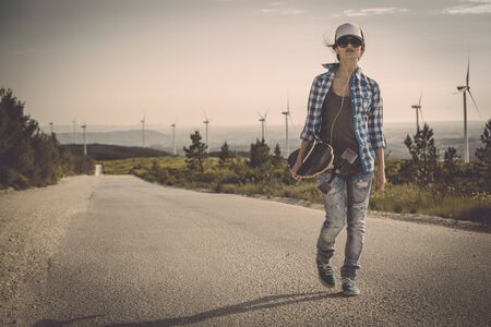 Beautiful Young woman walking her skateboardの写真素材