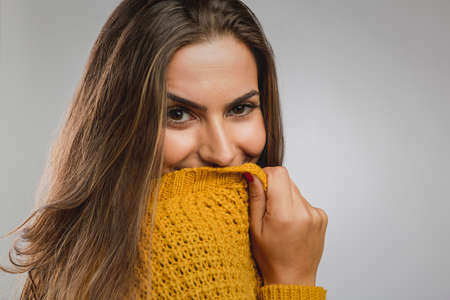 Portrait of a beautiful young woman over a gray background