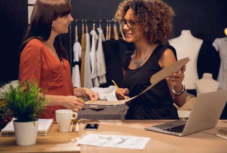 Two young entrepreneur women, and fashion designers working on the atelierの写真素材