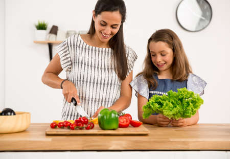 Shot of a mother and daughter having fun in the kitchenの写真素材