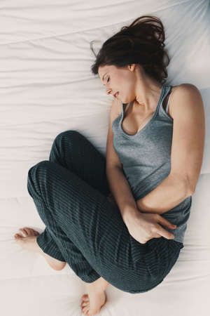Portrait of a young woman in pain with PMS, Premenstural Syndromeの写真素材