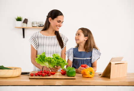 Shot of a mother and daughter having fun in the kitchenの写真素材