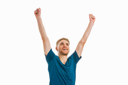 Happy young man with both arms up, isolated on white backgroundの写真素材