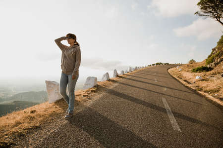 Woman walking alone on a sunny aftternoonの写真素材