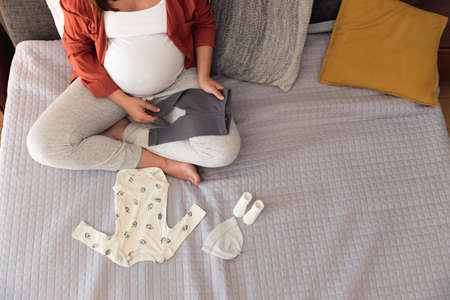 Pregnant woman packing a hospital bag preparing for laborの写真素材