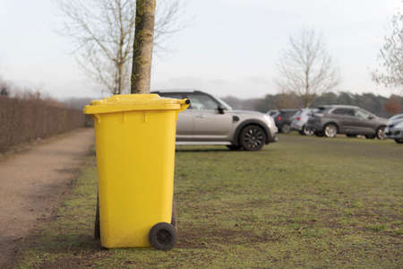 Yellow trash can in the car parkの写真素材