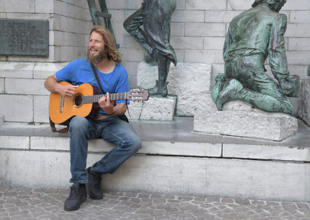 Antwerp - Belgium - 20.06.2021. Street musician guitarist and singer on Antwerp street