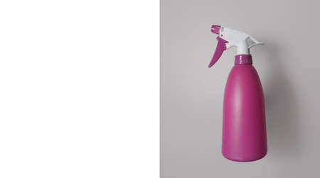 Plastic pink aerosol can on a gray background and white space for text. Card