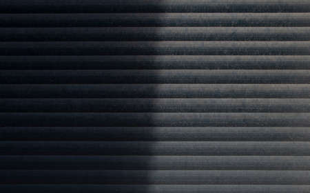 The texture of the old external blinds, with a vertical shadow. Traces of dust and age.の写真素材