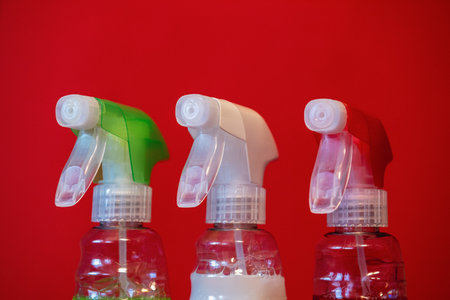 containers of cleaning agent on the red background. close-up