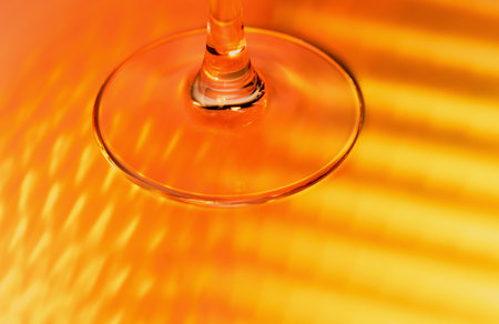 abstract background - stem of the glass and falling red and yellow rays. close upの写真素材