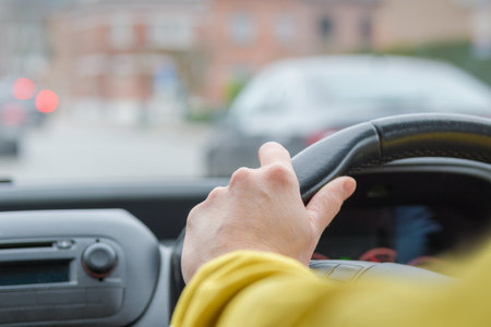Right hand drive. Windshield and perspective of the road. Steering. Selected Focus. Hand of woman on...