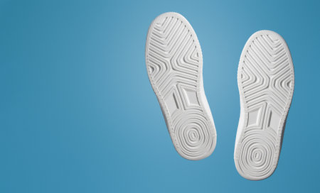 Two soles of sports shoe. White. Frontally on a blue background. Bannerの写真素材
