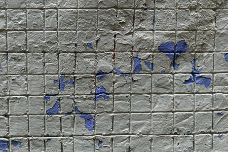 The texture of the concrete pouring of the facade of the building with an imprint of a metal mesh. Traces of peeling blue paintの写真素材