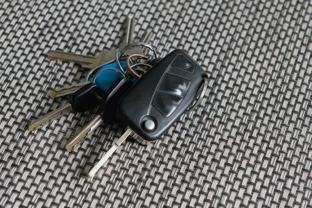 Bunch of keys on the table. Car, bike and apartment keys on texture table.の写真素材