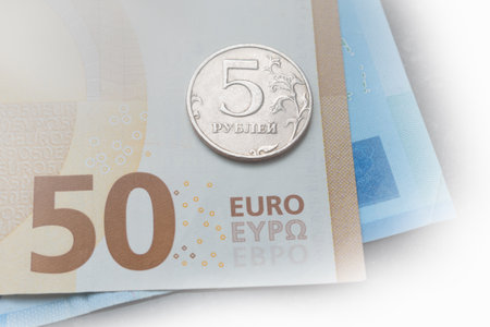Ruble exchange. Five rubles and fifty euros. Close up. White background