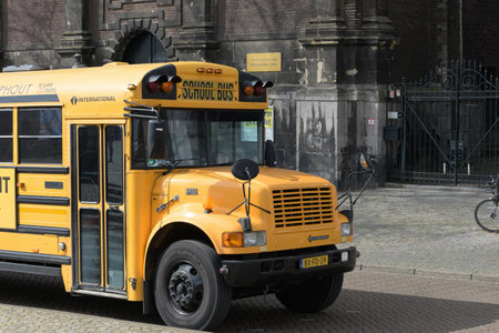 Maastricht. Limburg - Netherlands 10-04-2022. Front of a classic yellow school bus adapted for tourist tripsのeditorial素材