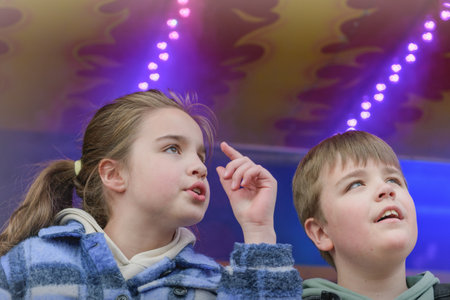 Portrait of a teenage girl and a boy in an amusement park.の写真素材