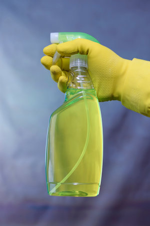 A man hand holds a mockup container of detergent. purple background. Copy spaceの写真素材