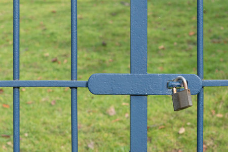 The gate is locked with a metal padlock. Close upの写真素材