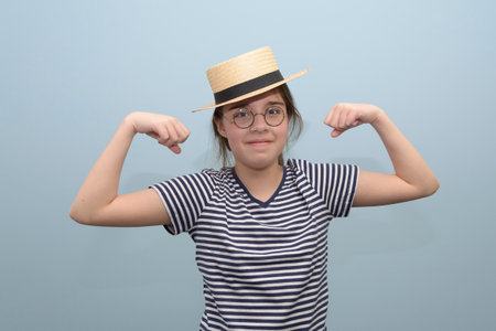 Retro sketch - Funny girl in a striped t-shirt, straw hat and glasses shows strength in the biceps