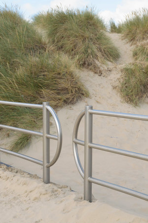 Fences from aluminum in the dune area on the beach for pathsの写真素材