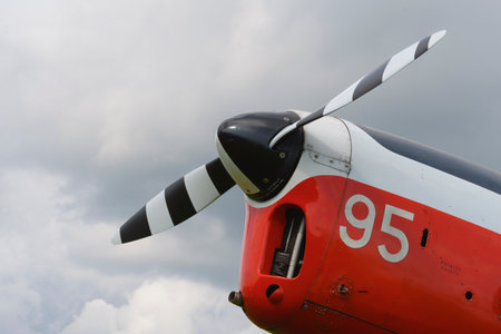 A red light aircraft fragment with a propeller of the front part of . Close-up, screws, texture, surfaceのeditorial素材