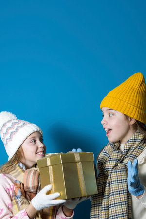 The joy of a gift. Two teenage friends exchange gifts. Winter, Christmasの写真素材