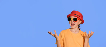 Teenage Belgian fan. Joyful girl in Belgian attributes, hat and glasses of the Belgian flag. Banner...