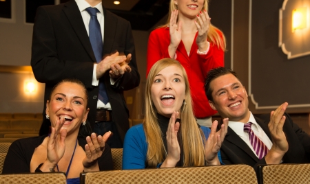 Audience in a theatre, on a concert or in a cinema clapping and applaudingの写真素材