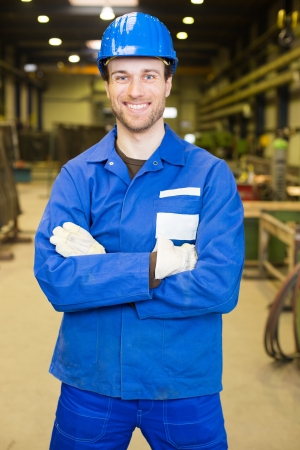 Construction worker with helmet in assembly hallの写真素材
