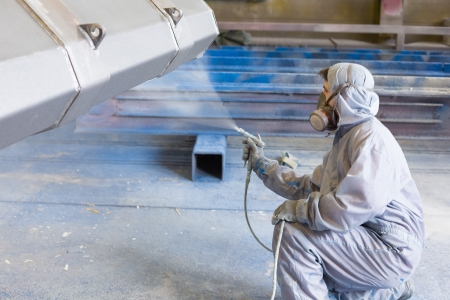 vehicle painter spraying white color on construction bucket vehicle painter spraying white color on construction bucket