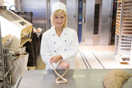 Baker forming a pretzel out of dough