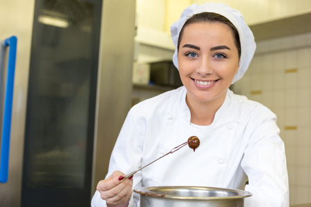 confectioner producing filled chocolates in confectionery