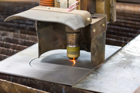Laser cutting machine cuts a steel metal sheet