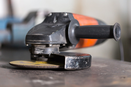 Close-up of angle grinder lying on a tableの写真素材