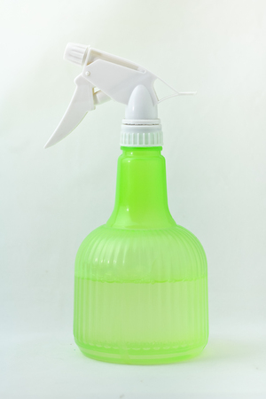 Green spray bottle  on white backgroundの写真素材
