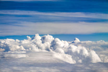 Aerial view on massive fluffy rain cloud and blue skyの写真素材