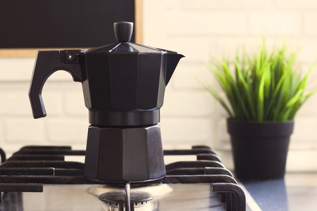 Coffee pot is on the stove in the kitchenの写真素材