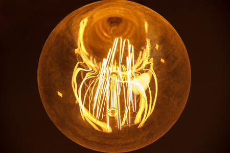 light bulb closeup burning in the dark