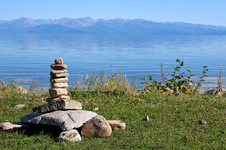 Stones folded in the form of a large turtle, on the shore of Lake Baikal. On the shell of the tortoise is a pile of stones. Siberia, Buryatia.の写真素材