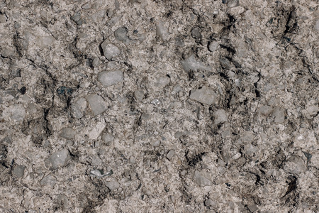 Fragment of a gray concrete wall with small white stones, clous up. Seamless texture for background. Repair, design concept.の写真素材
