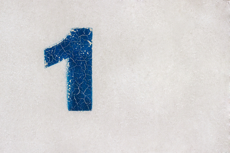 number 1 (one) is written in blue paint on a gray metal surface. background, textureの写真素材