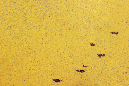 Surface of the old yellow metal  with peeling paint and rust spots. Background, Seamless texture.の写真素材