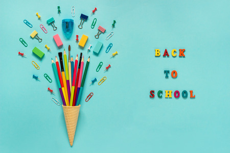 Stationery Pencils paintbrush paperclip in waffle ice cream cone. Text back to school Still life on...